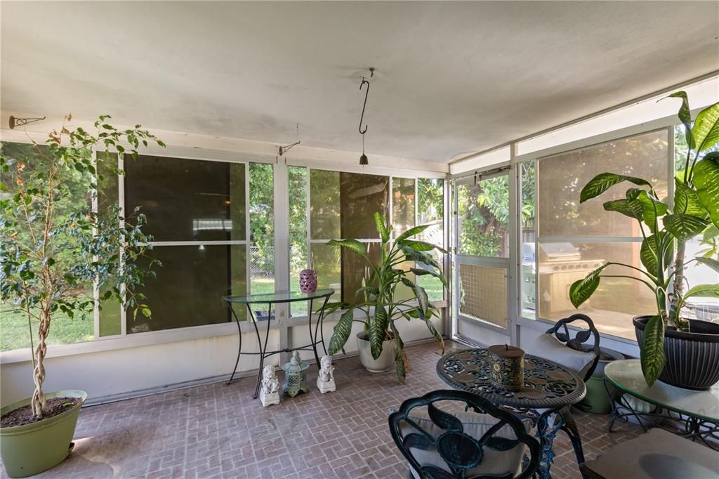 Screened in covered lanai with views of the back yard.