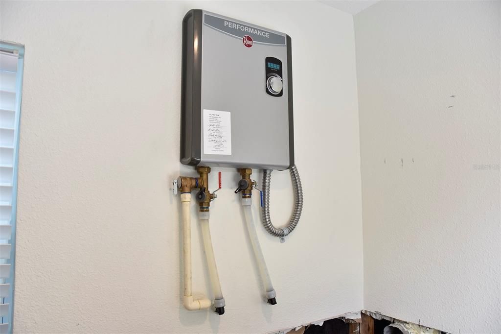 Tankless (gas) water heater in laundry room.