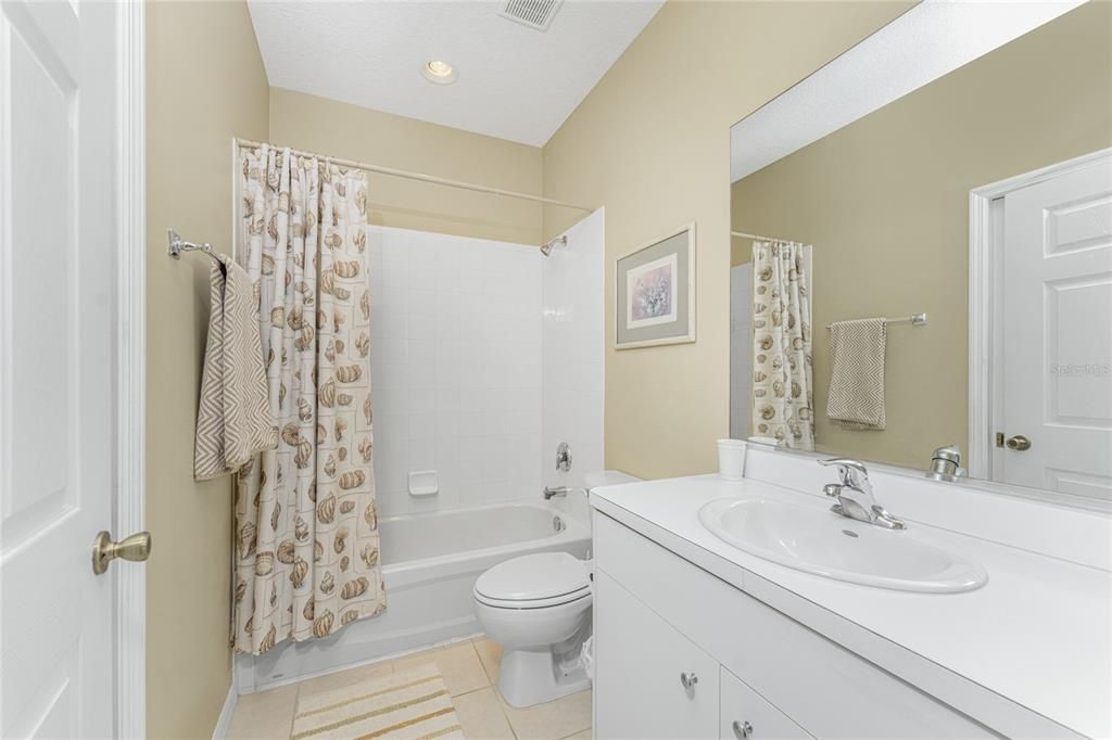 Guest bath has a combo tub/shower.