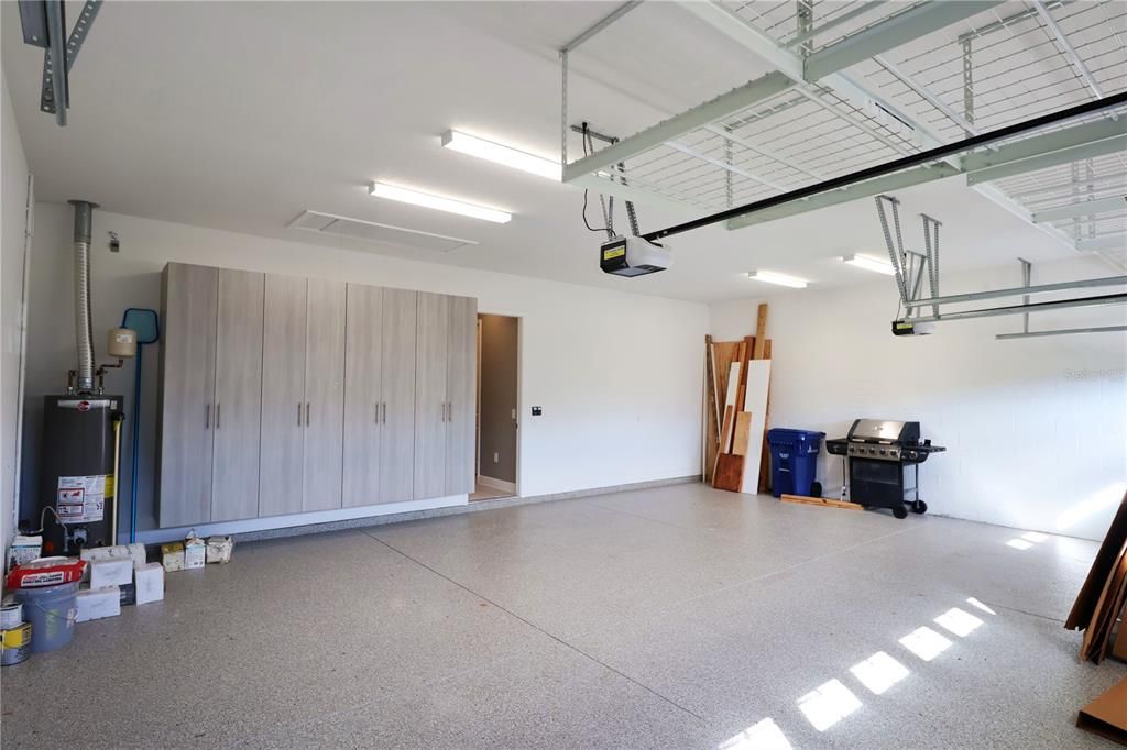 3 car garage with overhead storage and cabinet space.