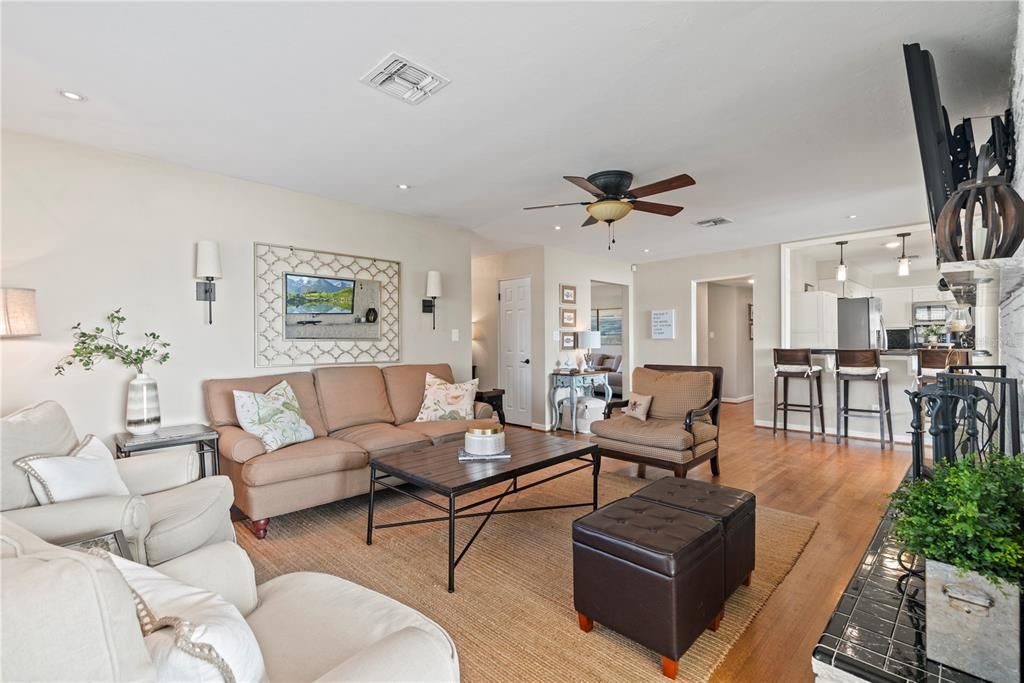 Living room with views into the kitchen