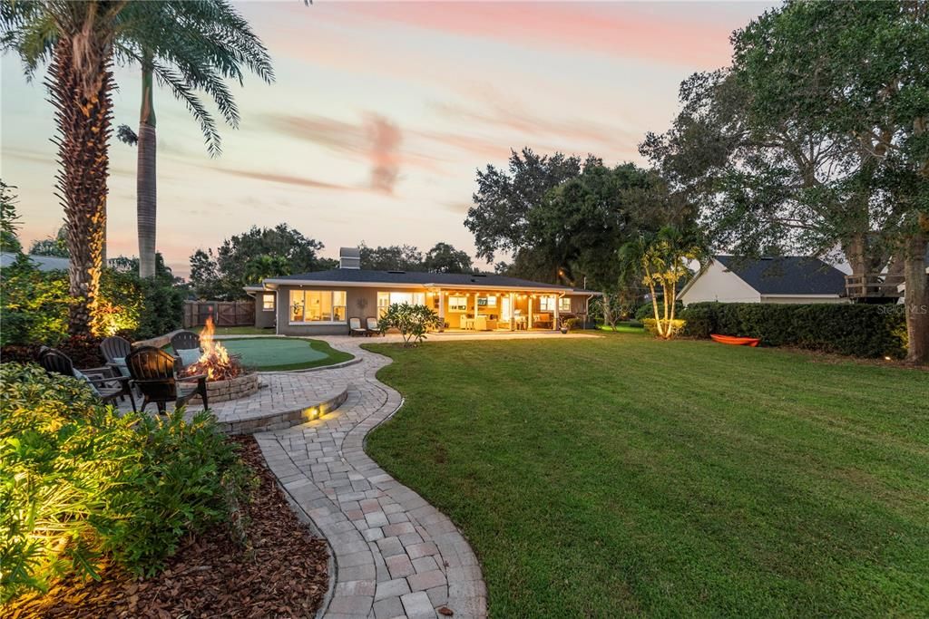 Large backyard with putting green and firepit