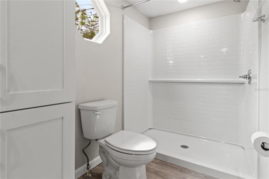 Primary bathroom with low maintenance shower