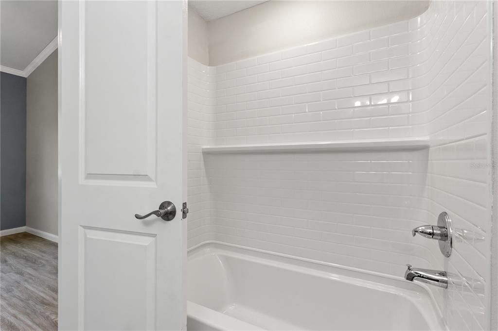 Guest bathroom with low maintenance tub shower combo