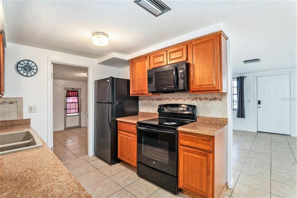 Galley kitchen with matching black appliances