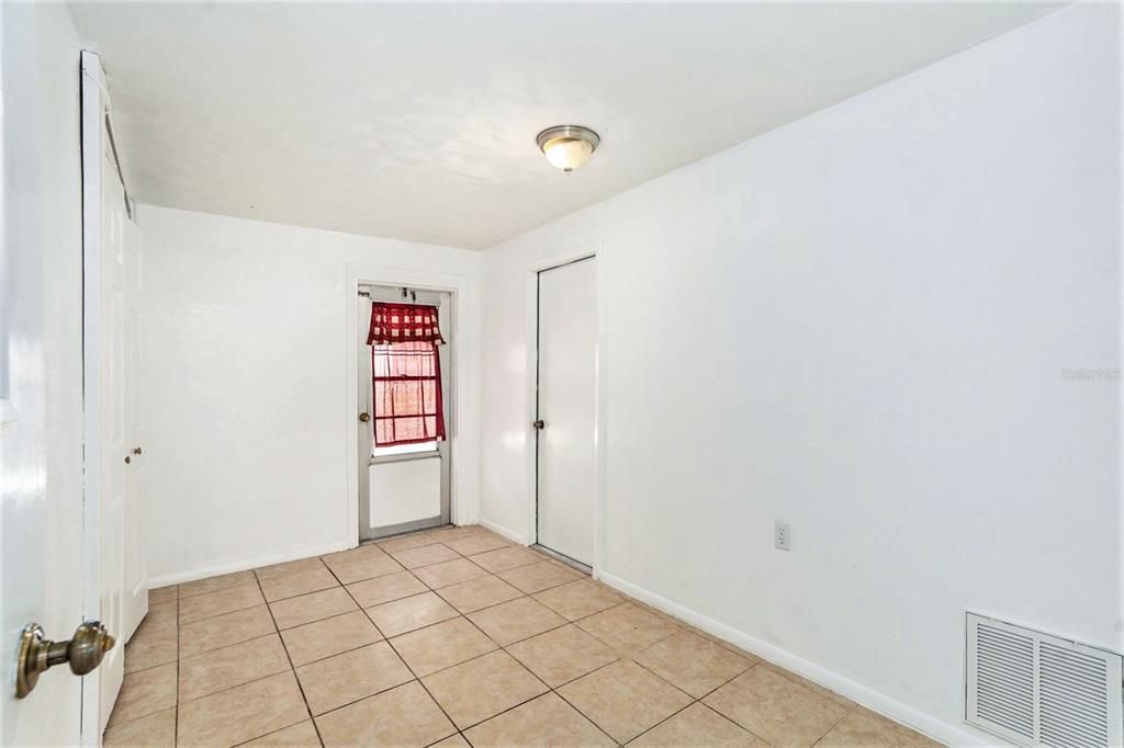 Small bonus room where the 1/2 bath is located and the laundry closet.