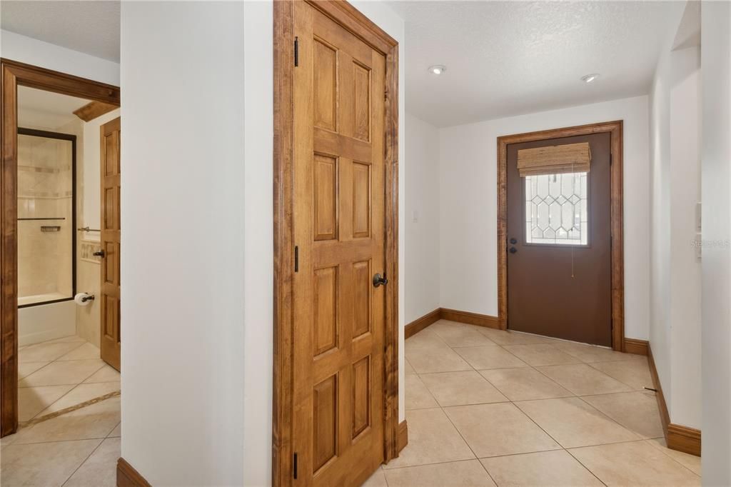 foyer with hallway and bedrooms on right as you enter