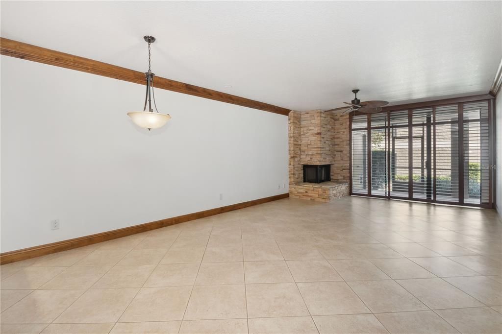 Living room / Dining room combo with fireplace and sliders to rear screened patio