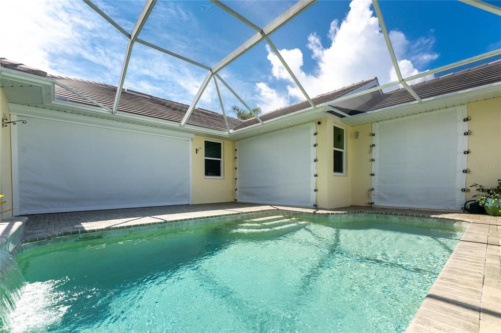 Sliding glass doors  seamlessly expand this tropical living space