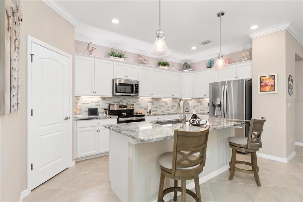 White cabinets, spacious kitchen.