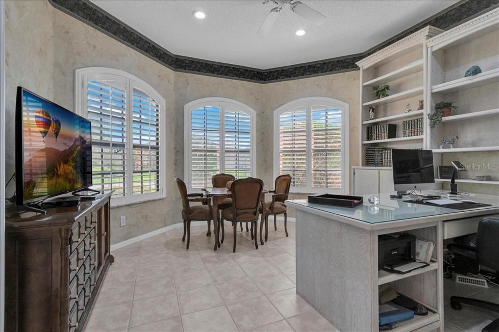 Home office at front of home with bay of windows