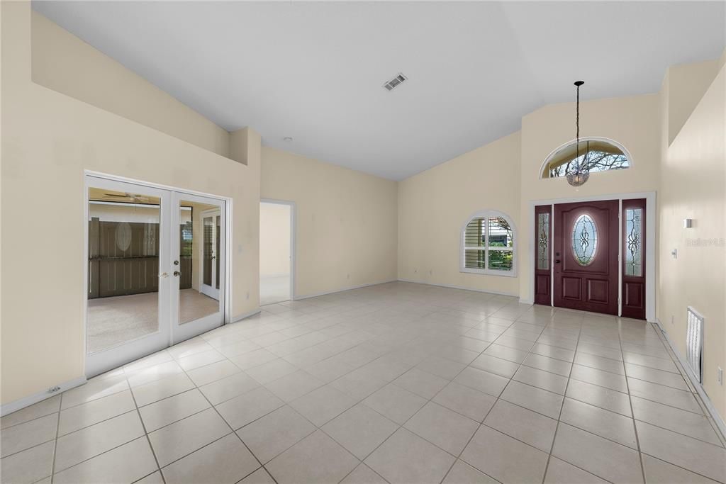 French doors from the living room lead to the sparkling pool.