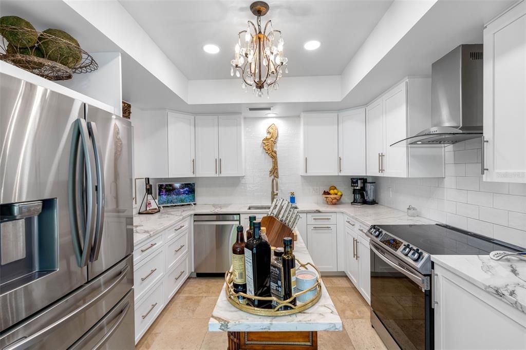 Stainless appliances, ample cabinetry, marble countertops