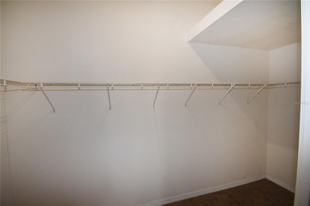 Master Bedroom Walk In Closet with overhead storage area