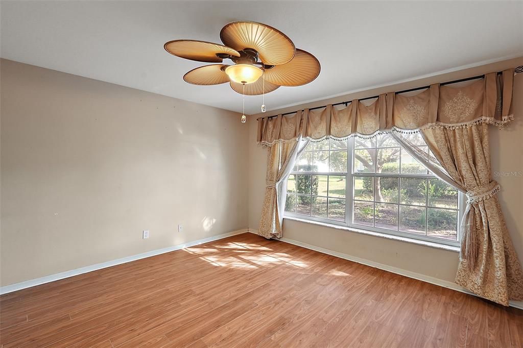 Large primary bedroom with lots of natural lighting.