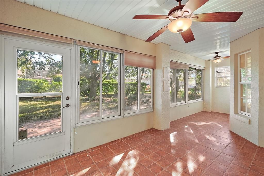 Large lanai with fans and slider windows.