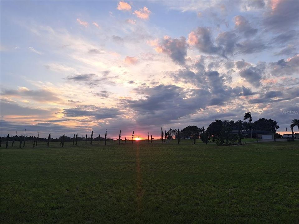 Sunset over the pasture and Crooked Lake.