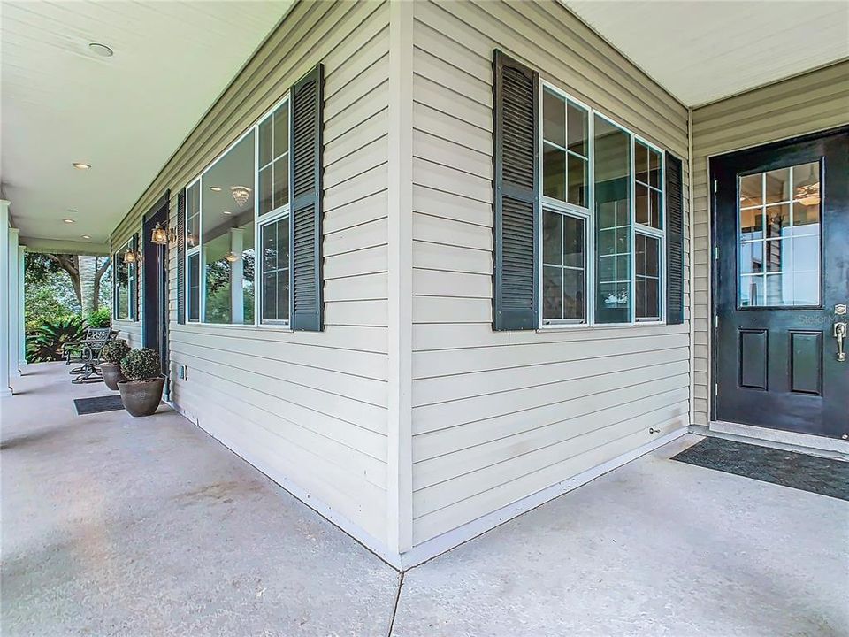 You will be welcomed as you walk to the front door with the 6’ wide wrap-around porch; this is a great place to enjoy stunning sunset views overlooking the pasture and Crooked Lake. A concrete walkway leads you to the front door.  The door at the right (in this picture) opens to the dinette area.