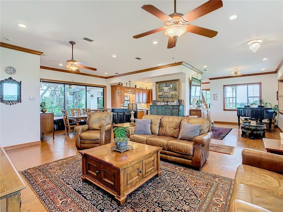 From this view you can see how easy the "flow" is between the living room, dining room and kitchen.  The front door opens to the 6' wide wrap around porch and the triple sliding glass doors in the dining room open to the screened pool/lanai.  Look at the amazing natural light that filters in thru the windows.