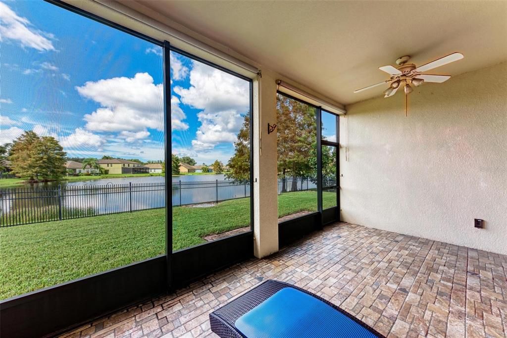 Extended screened-in lanai with views of the sparkling lake