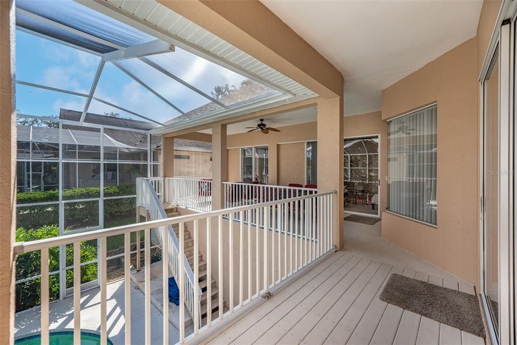 View of wrap around balcony and staircase to pool below.