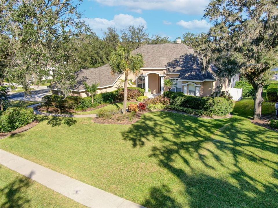 Lush landscaping and mature trees are breathtaking.