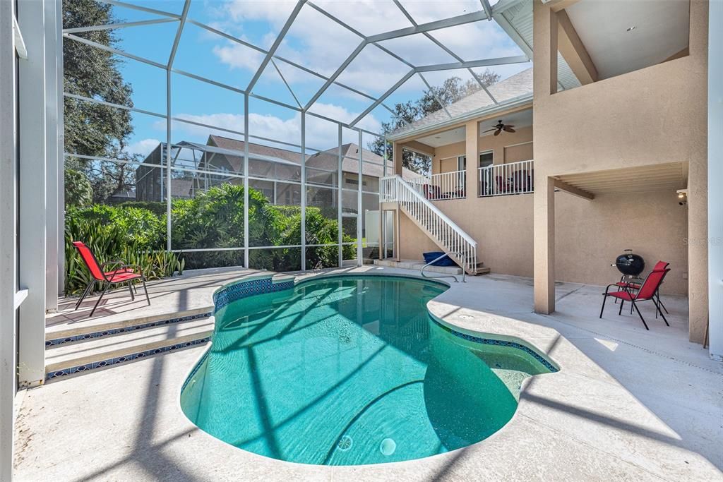 View of pool and staircase to 1st floor balcony.