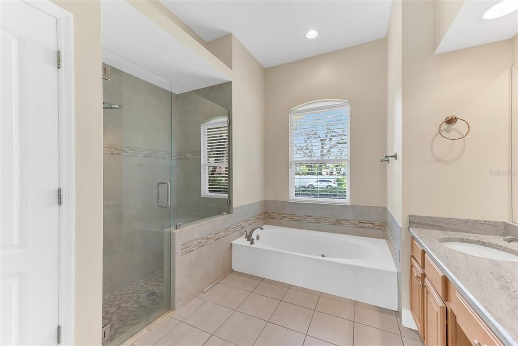 The owner's ensuite also has a large separate shower with frameless glass door and a water closet and linen storage closet.