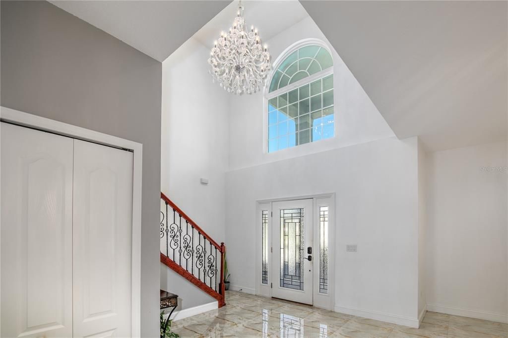 The cathedral ceilings draw your attention upward to the sparkling chandelier and grand staircase.