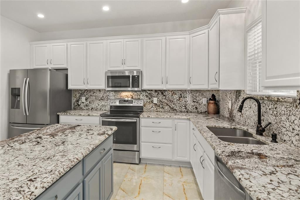 The island has extra storage cabinets and room for stools on the other side, making it an eat in kitchen.