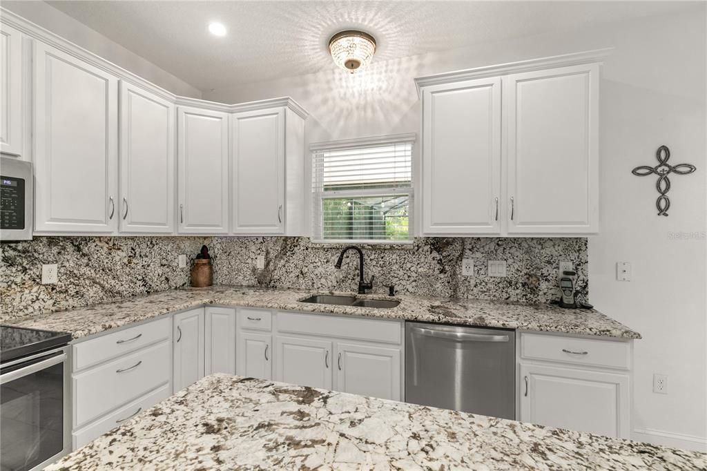 So much prepping space for the "Chef" in the family. A double stainless sink and dishwasher. You will always be a part of the activities with this wonderful open floor concept.