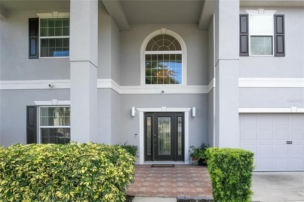 The beautiful entry to the home has a stunning leaded etched glass door with side lites, a paver porch and it's move-in ready. Let's go take a look...