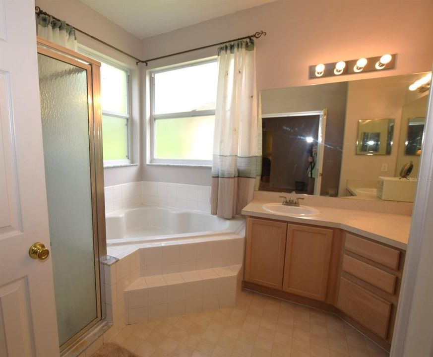 ...fully equipped ensuite with a separate shower, large vanity,  double sinks and garden/soaking tub for relaxing after a long day.