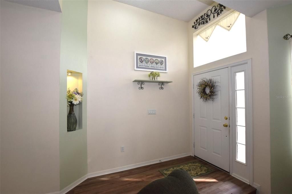 Natural lighting flows into the High ceiling entryway with a lit niche welcome you into this home.