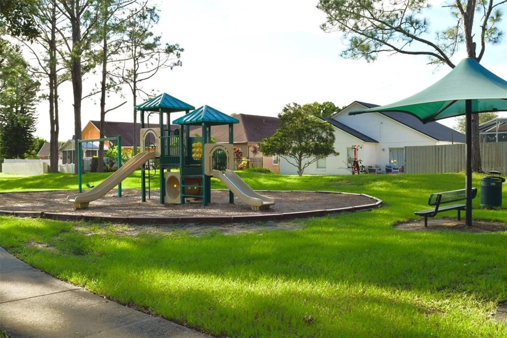 A playground for the children and a covered bench to enjoy the fun.