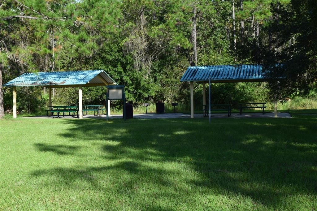 A picnic area with tables, and BBQ stations....