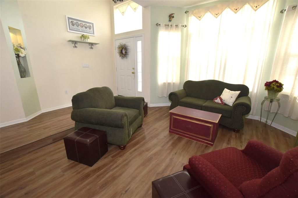 The sunken living room with lots of windows create an open, yet private area within the home.