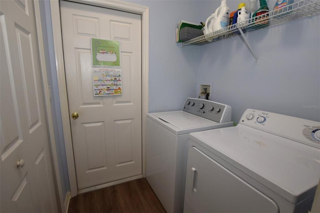 Laundry room equipped with washer & dryer has access to garage and a....