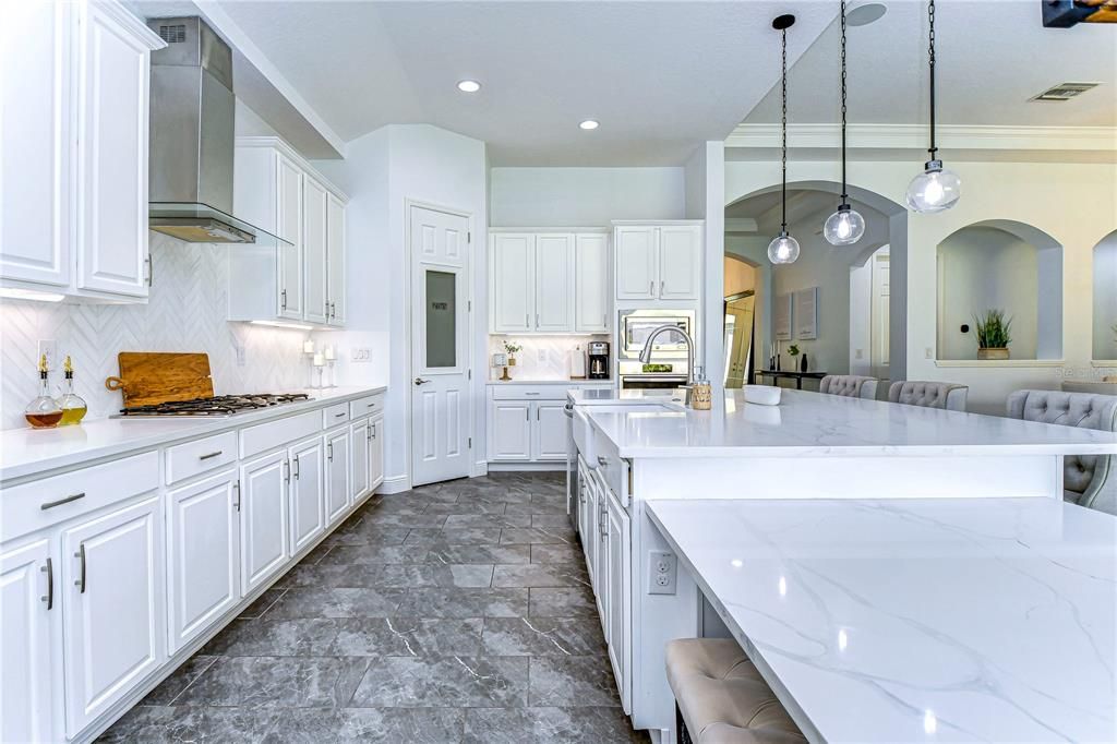 Luxurious quartz countertops and elegant light cabinetry!