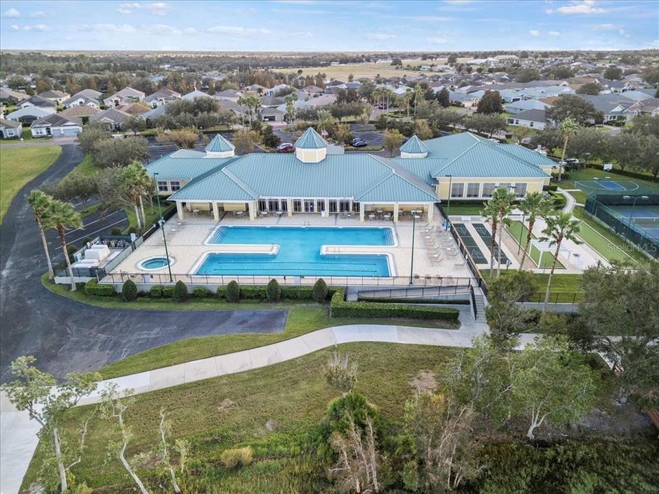 Aerial view of the 19,000 SQ.FT. Lakefront Clubhouse! Includes a walking trail, a heated pool, a spa, and a variety of other fantastic amenities for your enjoyment.