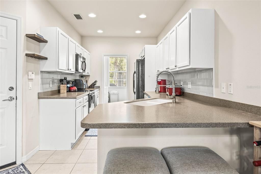 Galley Kitchen with lots of counterspace and white cabinets