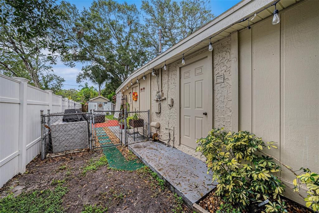 West side of the yard with laundry closet