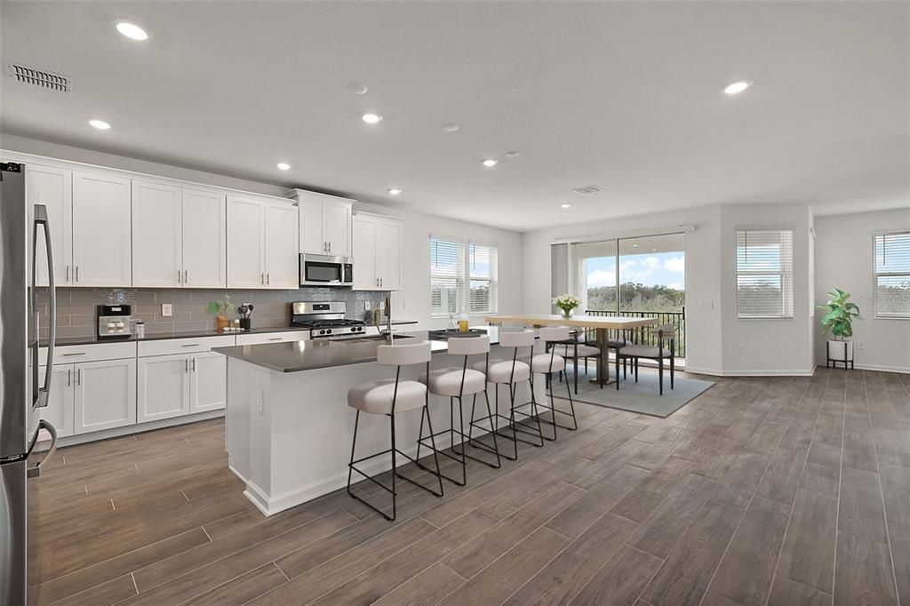 Open floorplan includes plenty of eating space at the bar and room for a kitchen table & chairs (virtually staged photo)