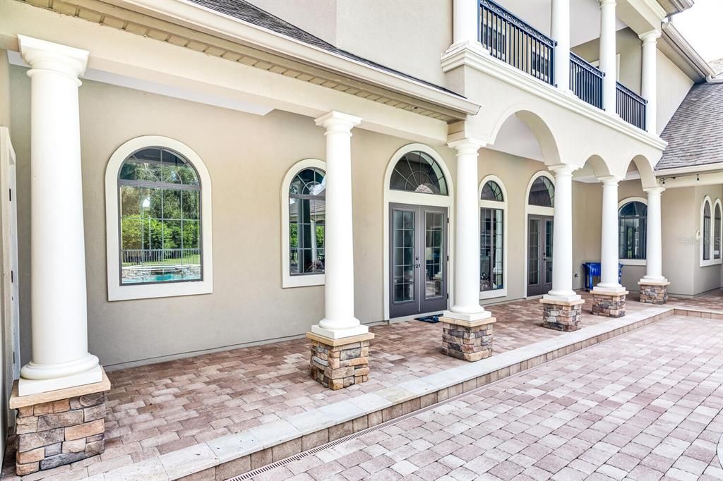 Pool Lanai With Paver and Travertine Patio