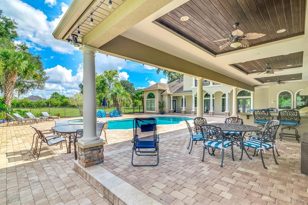 Pool Lanai With Paver and Travertine Patio