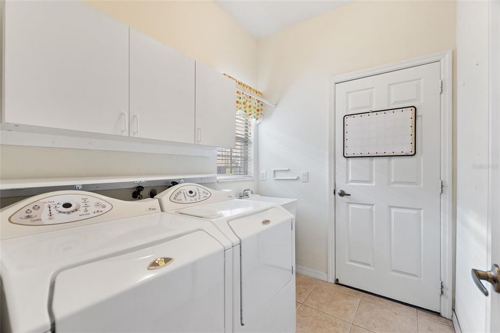 Maytag washer & dryer with overhead cabinets and closet pantry