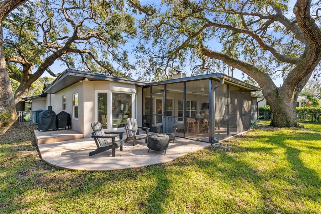 The outdoor living area continues with this additional patio space.   Perfect for a firepit.  It also wraps around to stow your grill and smoker!