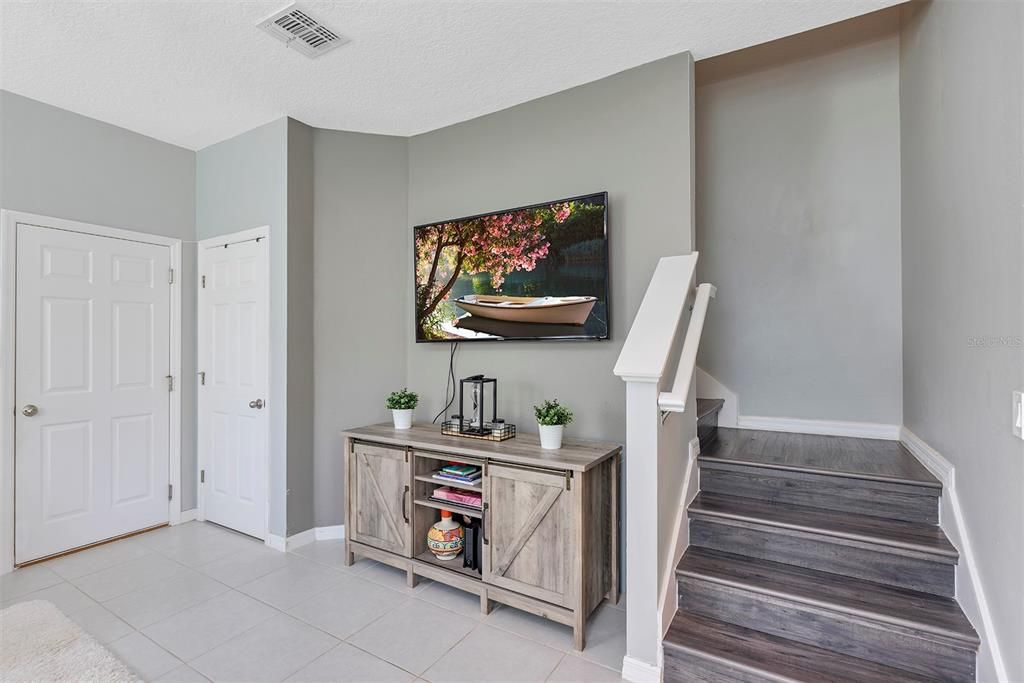 Living room with Garage entrance and under the stairs storage