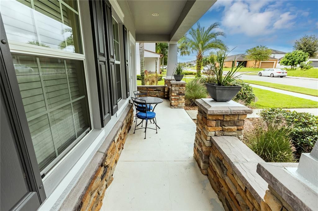 Front porch spacious enough for a table and chairs...you can even add some rocking chairs to enjoy the view of the courtyard across the street.