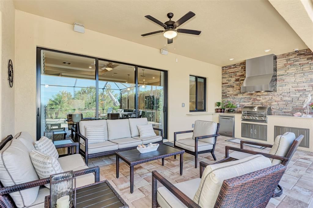 The outside lanai has a storm smart screens for our famous Florida storms, as well as an outside kitchen and lounge area.